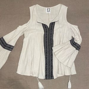 Cream with black and white, detailed stitching. long sleeve blouse